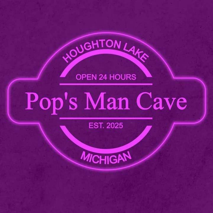 Illuminated pink neon-style man cave sign customized with a name and hometown location details.